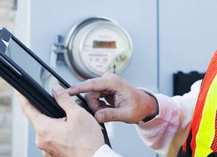 Worker Checking Meter With Tablet