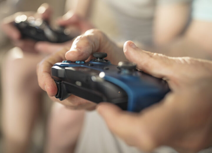Hands Holding Video Game Controllers