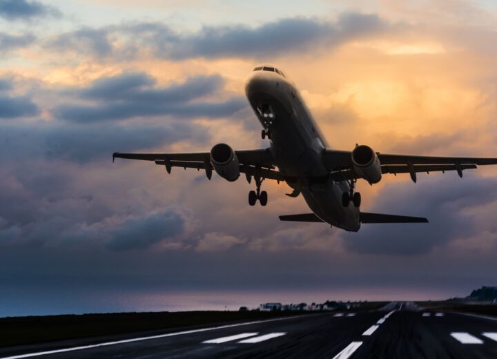 Airplane Taking Off At Sunset