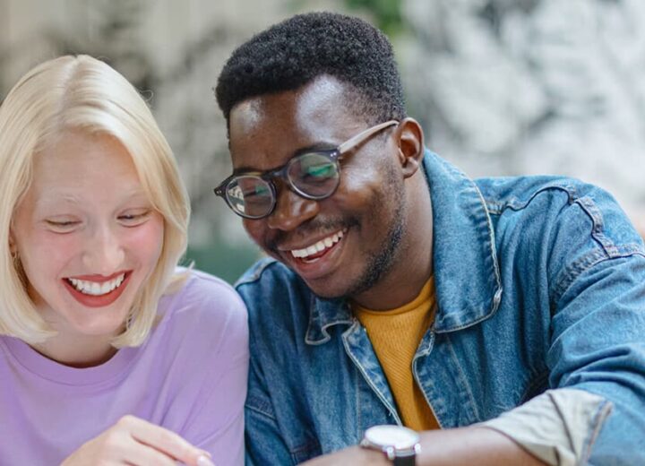Two People Collaborating At A Table.