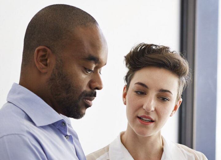 Two People Engaged In Conversation.