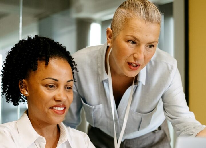 Two Professionals Collaborating In Office.