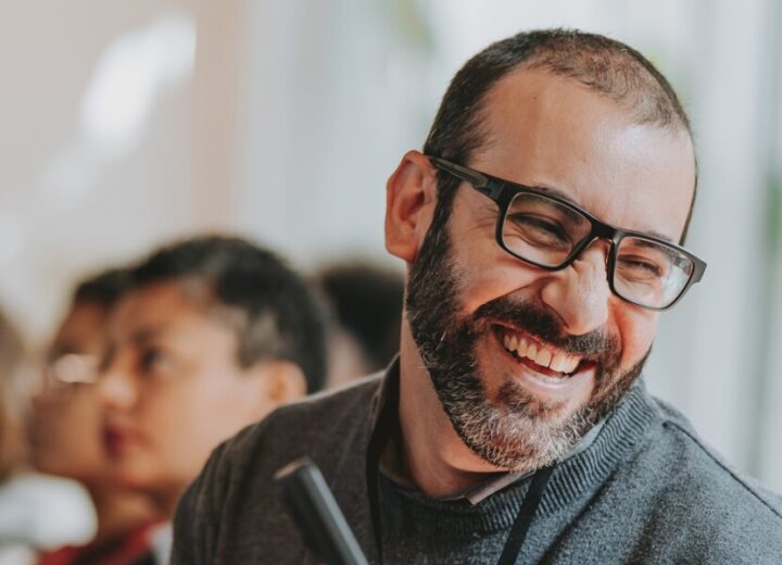 People Engaged In Conversation Indoors.